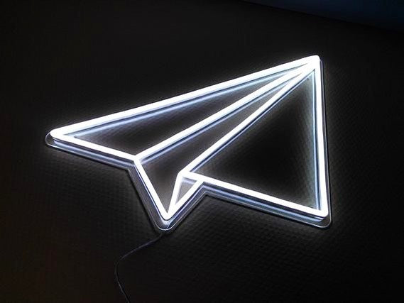 Airplane paper in neon sign factory